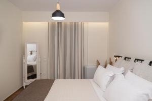 a bedroom with a large bed with white pillows at Maelia Samos Apartment in Ríva
