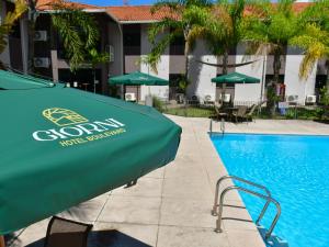 a swimming pool in front of a hotel at Giorni Hotel Boulevard in Resende