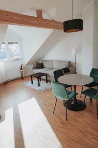 a living room with a couch and a table and chairs at FeWo Kibo Kupferberg in Kirchheimbolanden