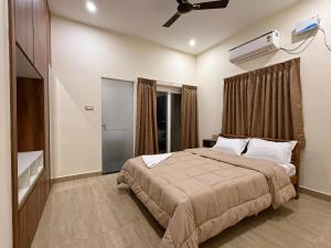a bedroom with a bed and a ceiling fan at Sree Devi Grande in Chennai