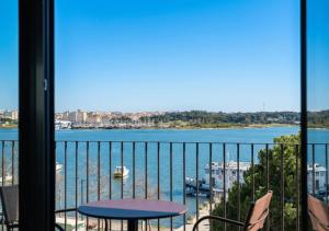 a balcony with a view of the water at Upon Harbor - Seixal Bay Hotel in Seixal