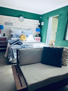 a bedroom with a bed with a bench in it at Tiny harties in Hartbeespoort