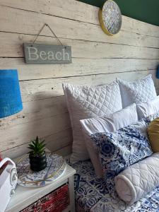 a room with a couch and a table with pillows at Tiny harties in Hartbeespoort +5 photos