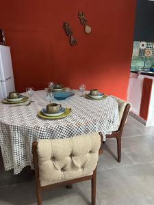 a table with plates and wine glasses on it at Tiny harties in Hartbeespoort