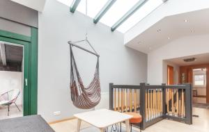 a hammock hanging from the ceiling in a living room at ötztalLOFT in Längenfeld