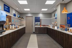 a store aisle with wooden cabinets and aasteryasteryasteryasteryasteryasteryasteryastery at Holiday Inn Express & Suites Phoenix - Midtown, an IHG Hotel in Phoenix