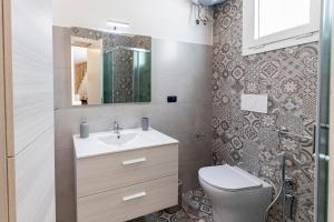 a bathroom with a sink and a toilet at La Curte - B&B in Melendugno