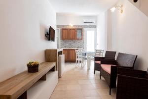 a kitchen and living room with a table and chairs at La Curte - B&B in Melendugno +7 photos
