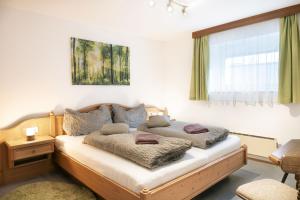 a bedroom with a bed with two pillows on it at Panorama Apartments Semslach in Obervellach