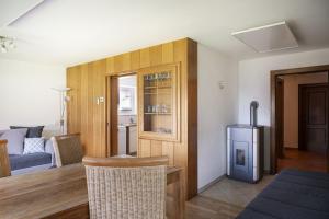 a living room with a table and a stove at Panorama Apartments Semslach in Obervellach