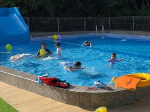 a group of people swimming in a swimming pool at RTMS Guesthouse Semporna in Semporna