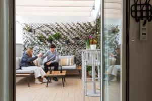 a man and woman sitting on chairs in a room at Zalamera BnB in Valencia +47 photos