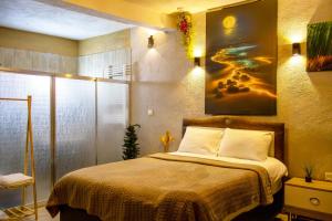 a bedroom with a bed and a painting on the wall at Seten House in Ürgüp