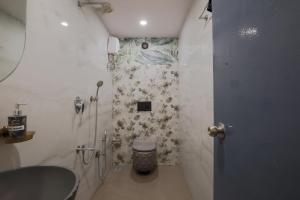 a bathroom with a sink and a tub and a toilet at De Classico Hotel Apartment in Mumbai