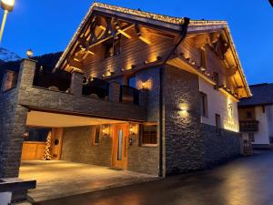 a large stone building with a porch at night at Chalet Theresia in Kappl
