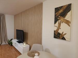 a living room with a table and a television at Central apartment in Staré Mesto