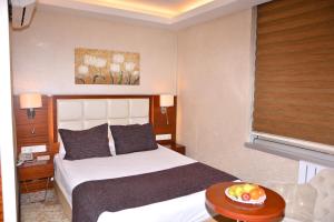a hotel room with a bed and a bowl of fruit on a table at Asrin Business Hotel Kızılay in Ankara +77 photos