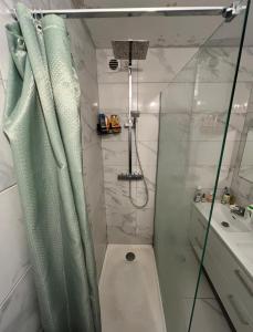 a bathroom with a shower with a toilet and a sink at Private Room in a Shared Appartment in Asnières-sur-Seine