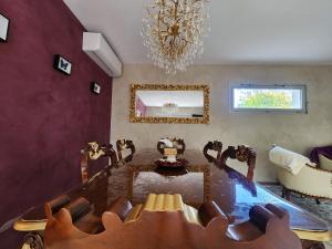 a dining room with a table and a mirror at Symphony - in Saint-Emilion in Saint-Émilion