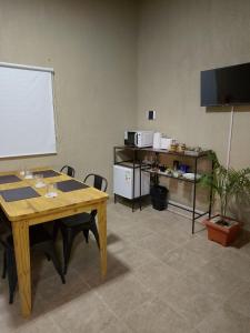 a meeting room with a table and chairs and a whiteboard at Dormis Talampaya in Villa Unión