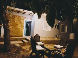 a group of chairs sitting in front of a building at Dormis Talampaya in Villa Unión