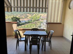 a table and chairs in a room with a window at Home 14 in Tortoreto Lido