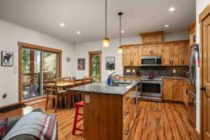 a kitchen with wooden cabinets and a table in a room at Moose Meadow in Welches
