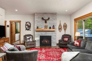 a living room with two couches and a fireplace at Moose Meadow in Welches