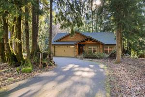 a house with a garage in the middle of trees at Moose Meadow in Welches