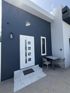 a blue wall with a table and two chairs at Viva Alto Vista! in Noord