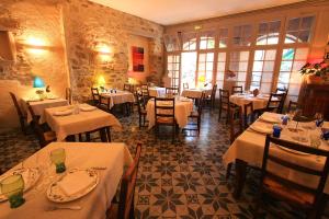 a restaurant with tables and chairs with white table cloth at Hôtel d'Alibert in Caunes-Minervois +27 photos
