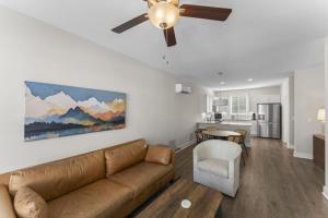 a living room with a couch and a ceiling fan at Riverview Retreat: Neyland Stadium – sleeps 8! in Knoxville