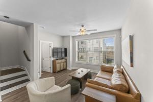 a living room with a couch and a window at Riverview Retreat: Neyland Stadium – sleeps 8! in Knoxville