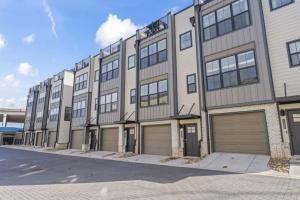 a large apartment building with four garages at Riverview Retreat: Neyland Stadium – sleeps 8! in Knoxville