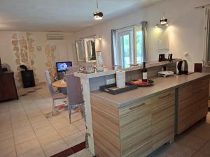 a kitchen with a counter and a dining room at Apartman MAKA in Kučiće