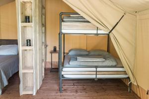 a room with two bunk beds in a tent at GlampKnox Canvas Campground - Grande in Knoxville