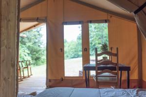 a room with a table and chairs in a tent at GlampKnox Canvas Campground - Grande in Knoxville