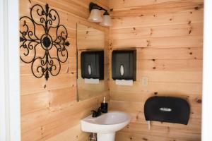 a bathroom with a sink and a mirror at GlampKnox Canvas Campground - Grande in Knoxville
