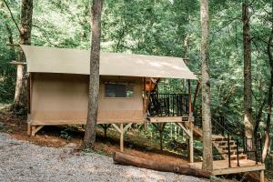 a tree house in the middle of the woods at GlampKnox Canvas Campground - Tree Solo in Knoxville