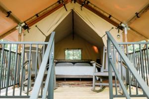 a bedroom in a tent with a bed in it at GlampKnox Canvas Campground - Tree Solo in Knoxville