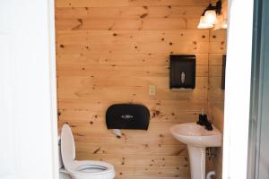 a bathroom with a toilet and a sink at GlampKnox Canvas Campground - Tree Solo in Knoxville