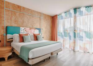 a bedroom with a bed and a large window at Upon Harbor - Seixal Bay Hotel in Seixal