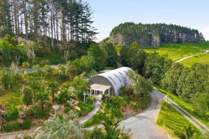 an aerial view of a greenhouse in a garden at Chic Converted Barn in Matakana with Spa in Big Omaha
