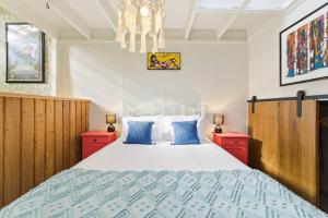 a bedroom with a bed and two red cabinets at Chic Converted Barn in Matakana with Spa in Big Omaha