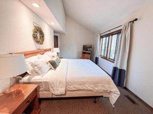 a bedroom with a large bed and a window at Sunbeam Shores 3Bed 3 Bath Pool-6PP in Osage Beach +45 photos