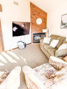 a living room with two couches and a flat screen tv at Sunbeam Shores 3Bed 3 Bath Pool-6PP in Osage Beach