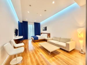 a living room with a couch and a bed at Condo Studio Plaza in Budva