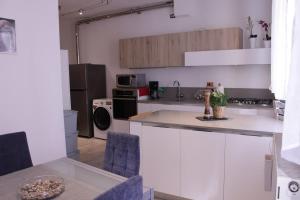 a kitchen with white cabinets and a counter top at Levico Nature Escape in Levico Terme