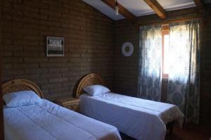 a bedroom with two beds and a window at Happy Trails in San Antonio