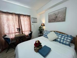 a bedroom with a bed with a basket of flowers on it at Hailey's Place Unit 2 in Bacolod